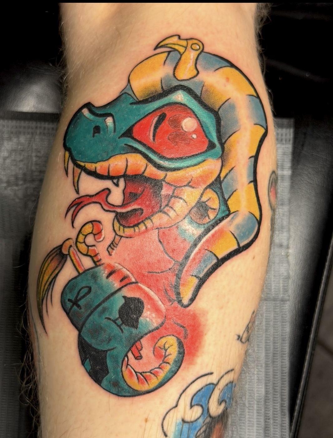 Colorful cobra wrapped around an Egyptian canopic jar tattoo