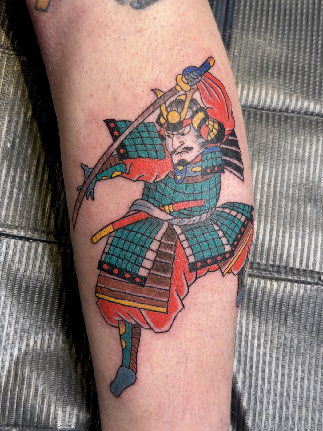 Color samurai warrior tattoo wielding a sword